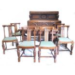 An oak dining room suite, each carved flowers, grapes, leaves, etc., comprising a bow fronted