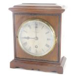 An early 20thC mahogany cased mantel clock, the metal dial with Roman numeric dial, the case