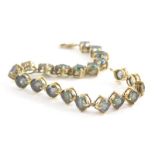 A 9ct gold sunset topaz bracelet, set with circular cut multi faceted topaz, 6.4 x 4.4, the yellow