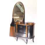 A continental ebonised and walnut dressing table, the raised back with oval bevel plate, the base