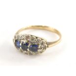 A 9ct gold sapphire and diamond dress ring, the oval ring head set with oval cut sapphires, in a