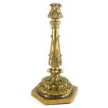 A late 19th/early 20thC gilt brass candlestick, decorated with leaves, drilled for electricity, 31cm