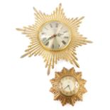 Two sunburst wall clocks, in silk plastic and silk metal cases.