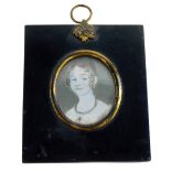 An early 19thC portrait miniature of a lady on ivory, in a black frame with gilt highlights, 7cm x