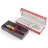 A Sheaffer brushed steel and brass effect fountain pen, in original case with outer sleeve, and a