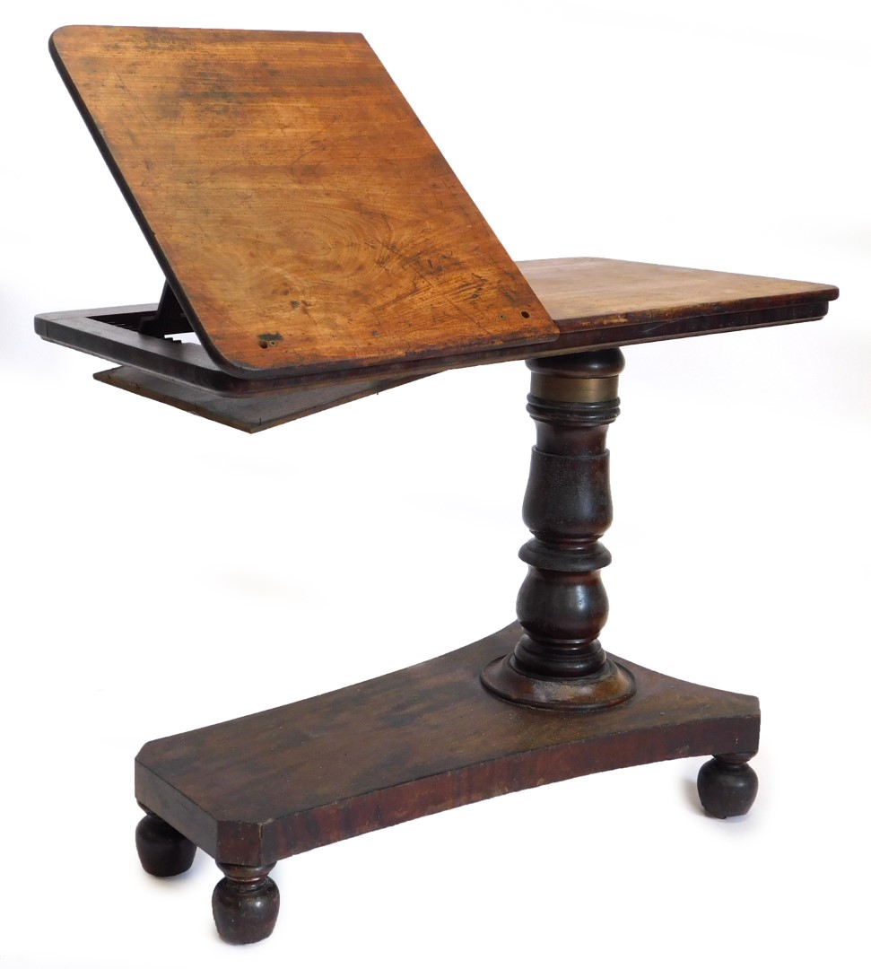 An early Victorian mahogany adjustable reading table, the rectangular top with a part hinged and