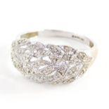 A 9ct gold dress ring, with cross over leaf design, set with tiny diamonds, in a white gold setting,