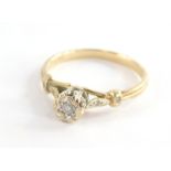 A 9ct gold diamond solitaire ring, on a raised setting with central stone approx. 0.10ct in an