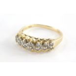 A 15ct gold dress ring, of half hoop design, set with tiny diamonds in claw setting with twist