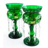 A pair of Victorian green glass table lustres, with gilt highlights, and various drops, 33cm high.