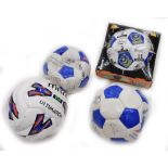 A collection of four signed footballs, to include Portsmouth.