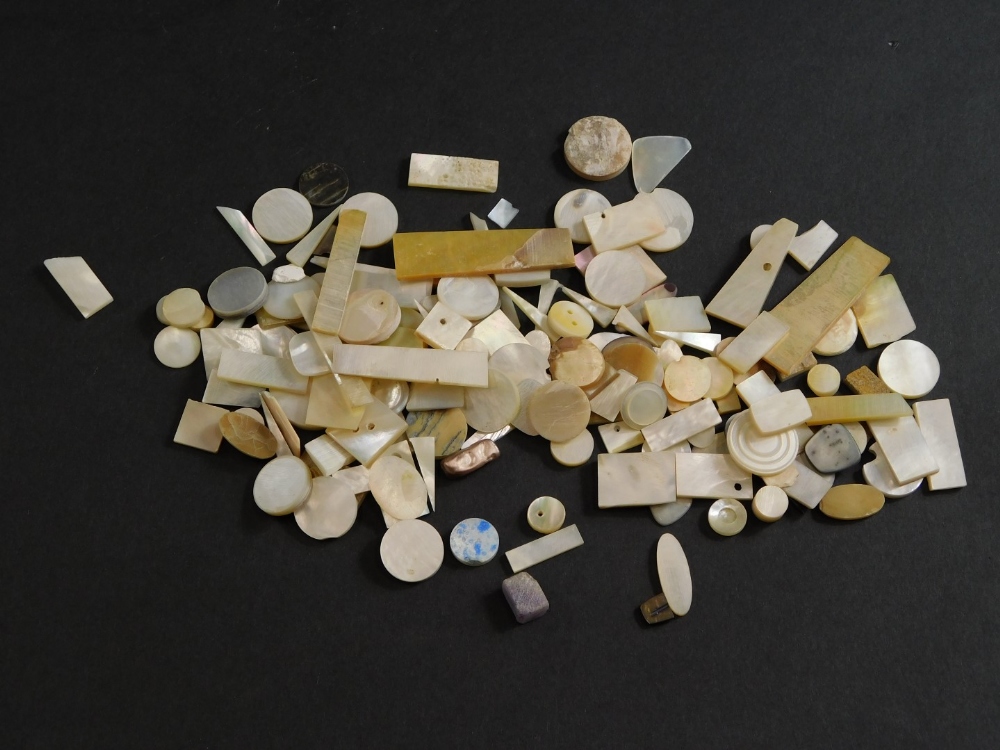 A collection of carved mother of pearl gaming counters, mainly small pieces.