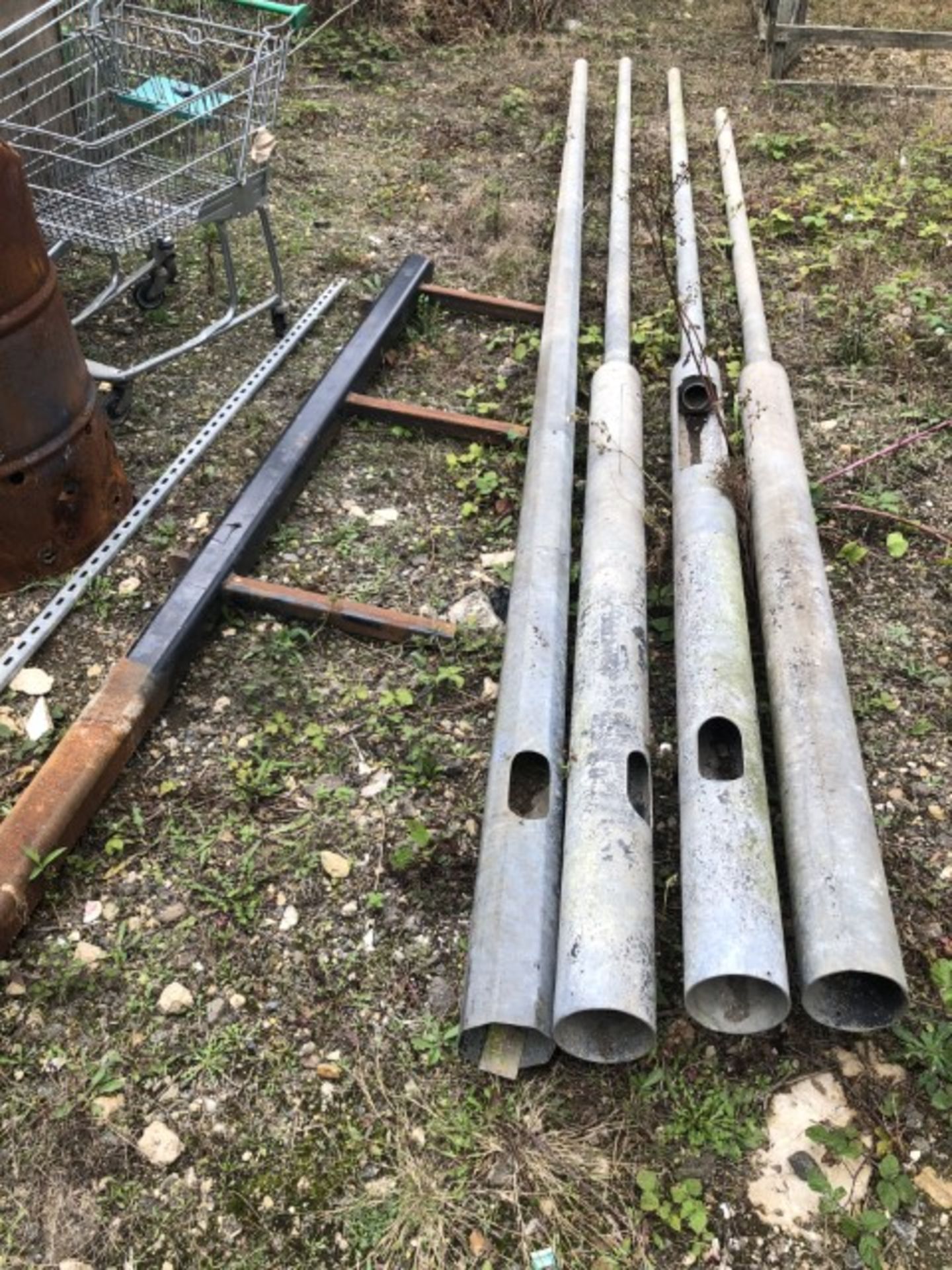 A three spike steel spur and four galvanized steel lamp standard posts. (Collection for this lot is