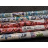 Various rolls of wallpaper.