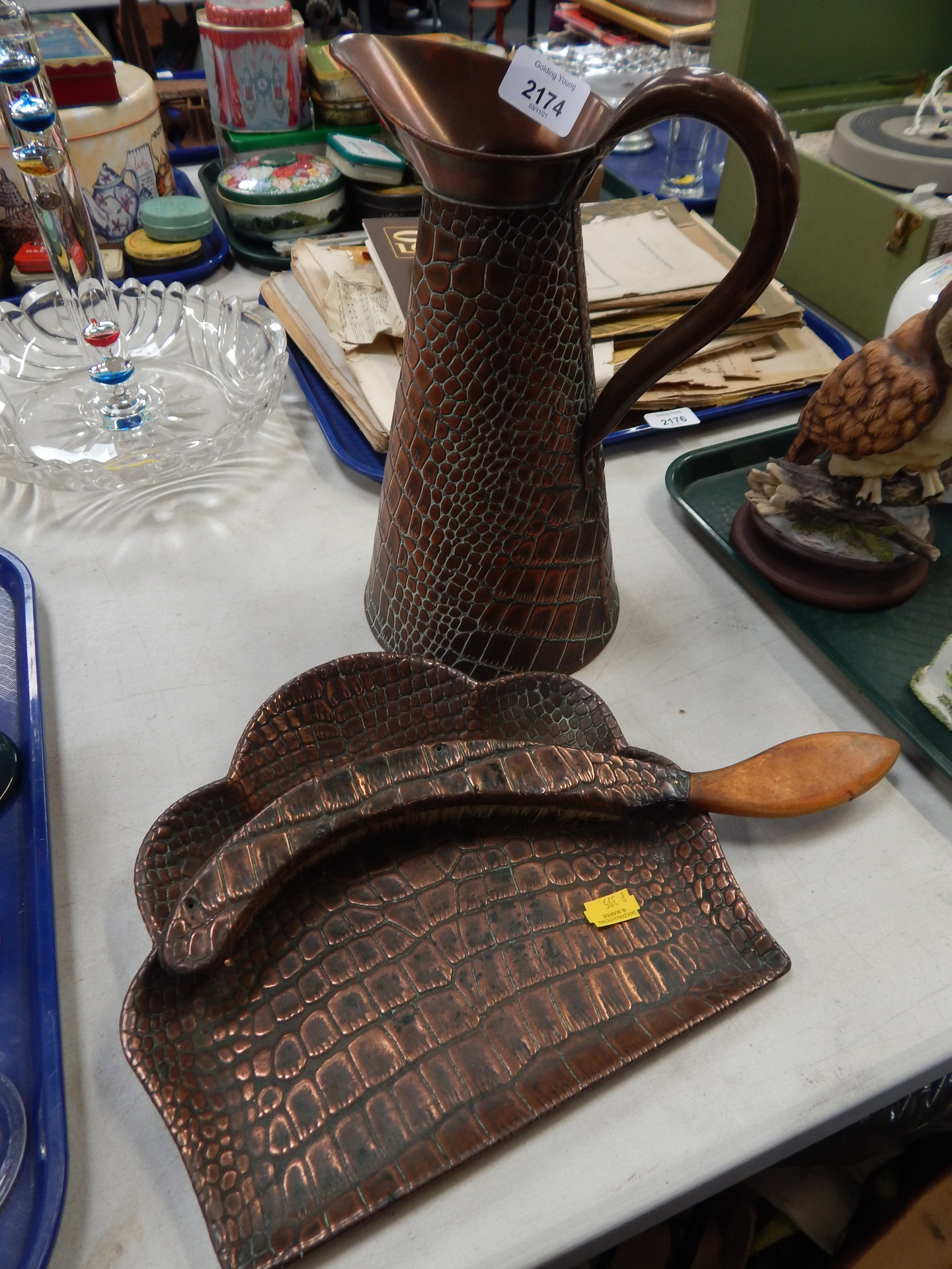 A hammered copper water jug, and crumb scoop, in crocodile skin type finish.