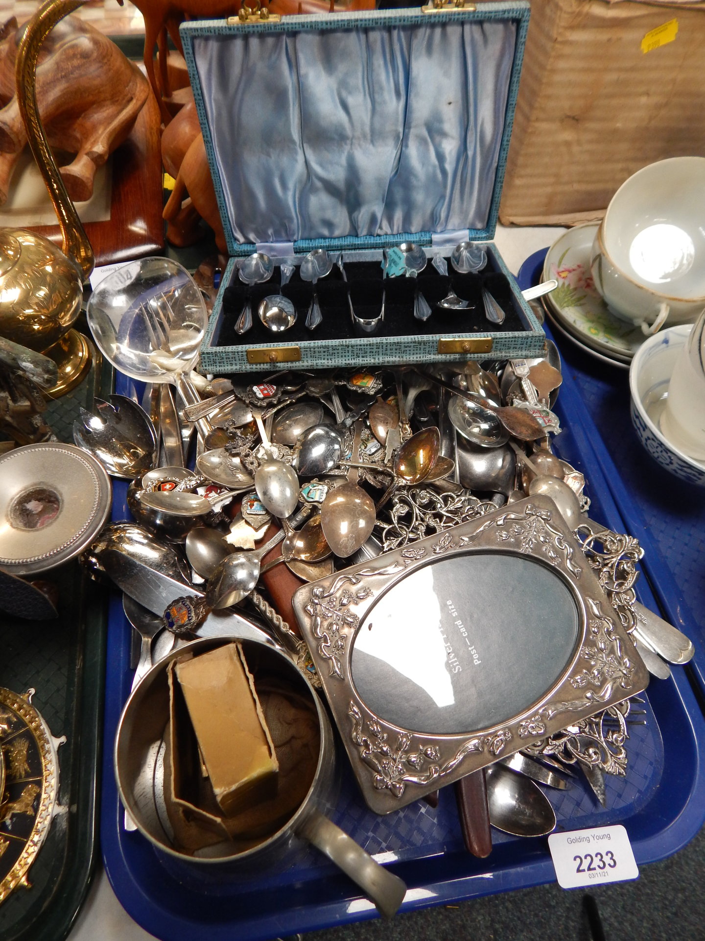 A group of silver plated wares, silver plated frames, souvenir spoons, cased cutlery sets, etc. (1 t