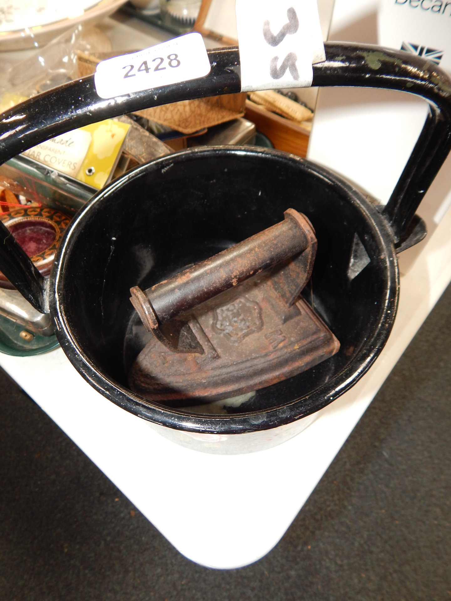 A continental metal milk pan, painted with roses, together with a vintage iron.