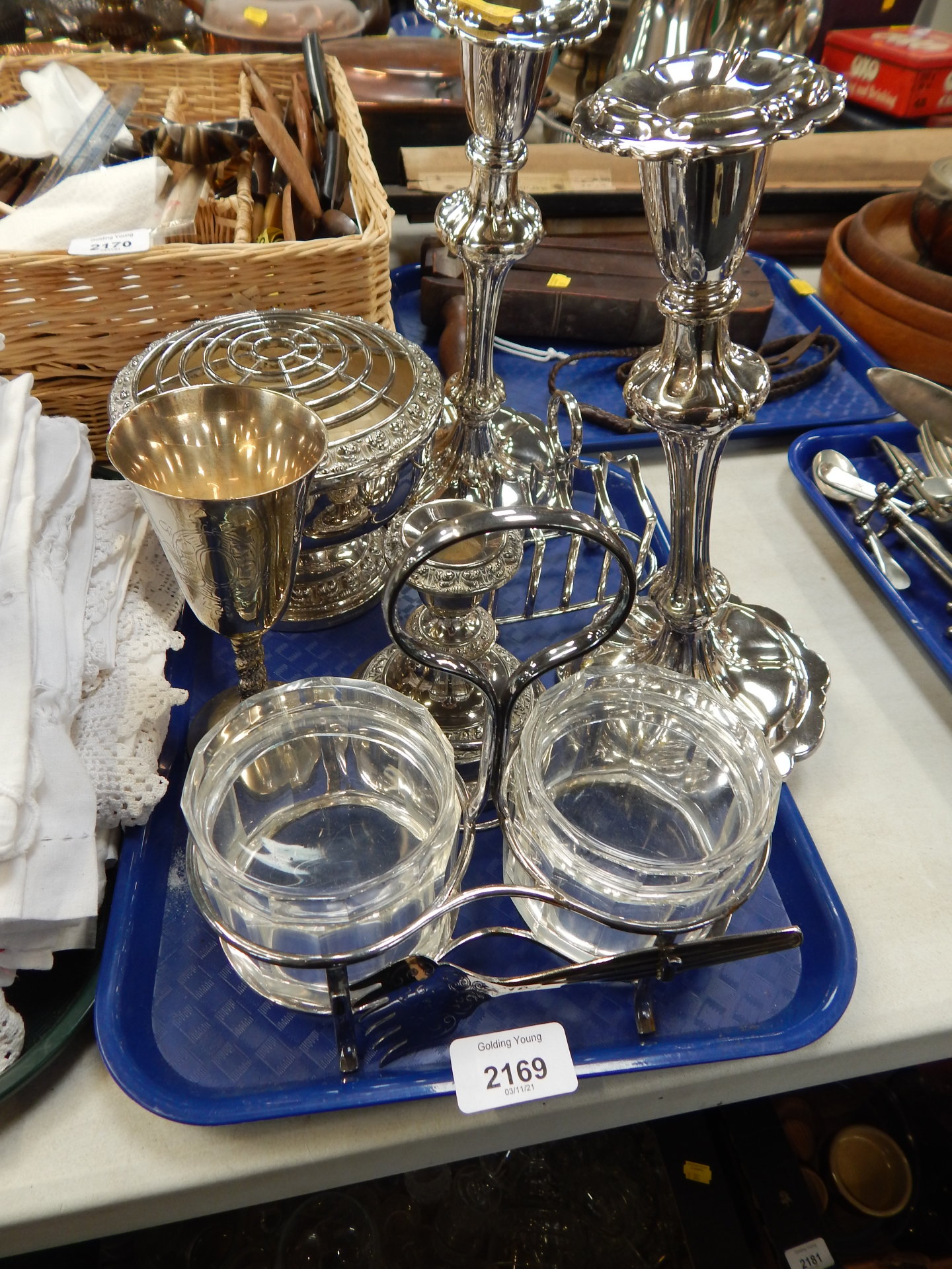 Silver plated wares, to include a pair of silver plated candlesticks, candle stand, toast rack, rose
