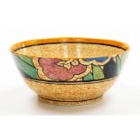 A Clarice Cliff bizarre bowl, on a mottled orange ground, decorated with flowers, leaves, etc., 17.5