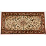 A Royal Khan Persian style rug, cream and red ground, decorated with a central medallion, flowers an