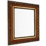 An early 20thC wall mirror, with rectangular mirror plate, with outer oak border and gilt twist flor