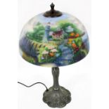 A Thomas Kinkade table lamp, the reverse decorated shade decorated with a cottage, lighthouse and se