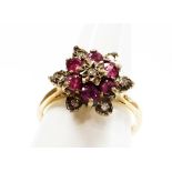 A 9ct gold dress ring, with central garnet and cz cluster, on a raised basket setting, ring size L½,