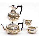 A Victorian Neoclassical design silver four piece service, with a part fluted design body and ebonis