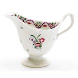 A late 18thC Newhall porcelain helmet shaped cream jug, pattern number 172, with rose spray decorati