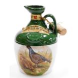 A Rutherford Scotch Whisky decanter, transfer printed with pheasants, with contents (unopened), 20cm