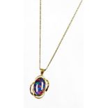 A fire opal pendant, with waved design outer border, yellow metal, marked 375, 2.5cm high, on a plat