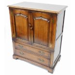 A Titchmarsh and Goodwin oak television cabinet, with two cupboard door top above two long drawers,