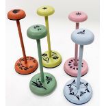 Five hand painted hat stands, with compressed mushroom tops, plain cylindrical stems, and circular b