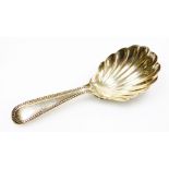 A Victorian silver caddy spoon, with a shell pattern bowl and beaded handle, Exeter 1876, 9cm long.