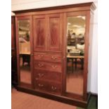 An Edwardian Maple and Co mahogany triple wardrobe, the dentil cornice raised above a boxwood inlay