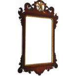 An early 19thC mahogany fret frame wall mirror, with a hoho bird crest, 74cm high, 44cm wide.