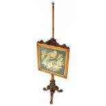 A Victorian walnut pole screen, the square framed panel embroidered with a parrot on branch etc., wi