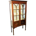 An Edwardian mahogany painted and boxwood strung display cabinet, the plain fixed cornice raised abo