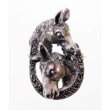 A silver and marcasite set horse brooch, with two horses heads over a horse shoe, stamped 925, with