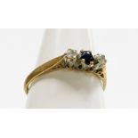 A 9ct gold three stone dress ring, set with tiny sapphire and two diamonds, each in claw setting, ri