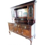 An Edwardian mahogany mirror back sideboard, the dentil top raised above a bevelled glass, flanked b