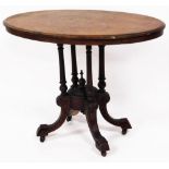 A Victorian oval walnut table, with marquetry inlaid top above four out splayed carved legs, 73cm hi