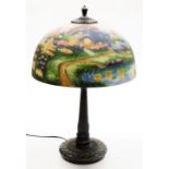 A Thomas Kinkade table lamp, the reverse decorated shade decorated with a lake and cottage scene, on