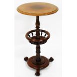 A 20thC mahogany finish stand, the circular top raised above baluster column, with central section o