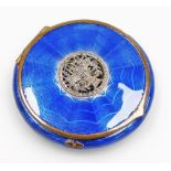 An early 20thC blue guilloche enamel decorated powder compact, with a silver coloured metal flower b