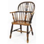 A 19thC ash and elm Windsor chair, with a pierced splat, solid seat on turned legs with H stretcher,