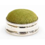 A late 19th/early 20thC silver collared pin cushion, with a sage green corded top, the leather base