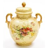 A Royal Worcester blush ivory porcelain two handled vase and cover, decorated with flowers and gilt