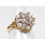 A 9ct gold dress ring, with central cluster design, set with seed pearls and cz stones, with star po