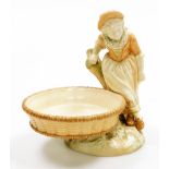 A Royal Worcester blush ivory porcelain sweetmeat dish, formed as a girl in bonnet leaning against a